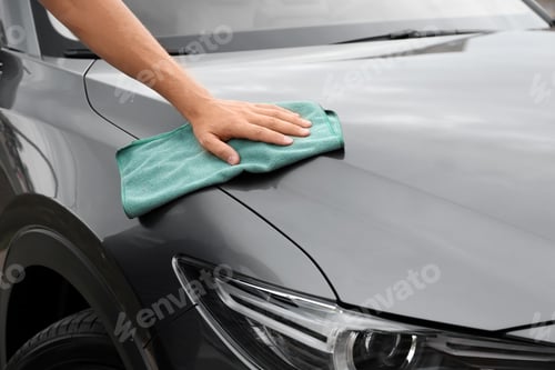Preview: Man washing car hood with rag, closeup