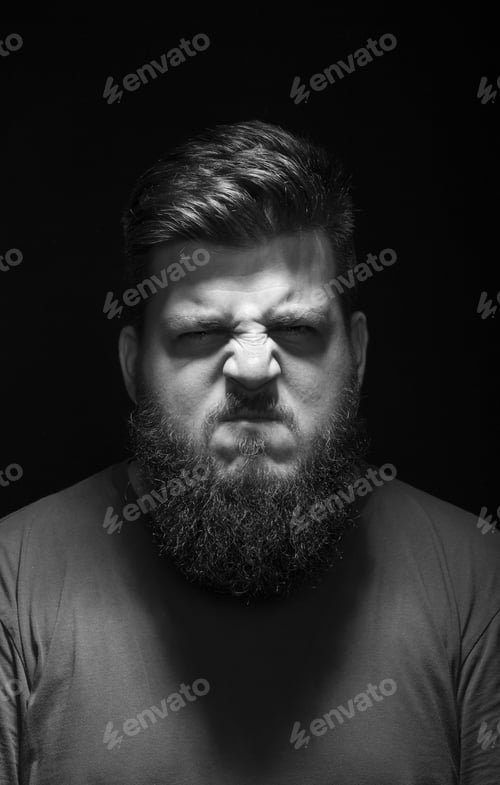 Preview: Very Angry, And Aggressive Male Portrait. Black Background, Low Key.