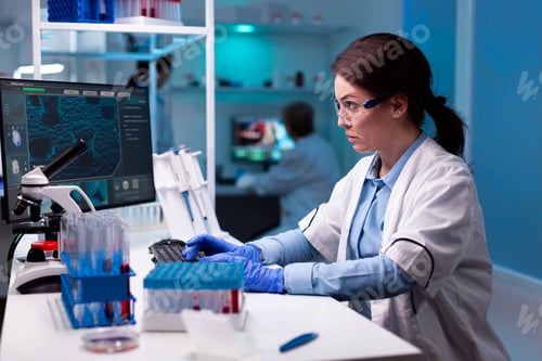 Preview: Woman doctor in health care development typing on computer