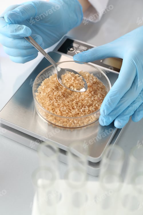 Preview: Scientist weighing Petri dish with sample on scales at white mirror table, closeup