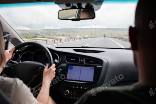 Preview: Couple in car traveling. Route navigator map, back view