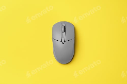 Preview: Gray computer mouse on yellow background top view