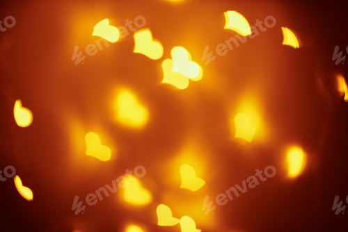 Preview: Abstract background with a golden blurred lights in heart shape. Valentine day concept