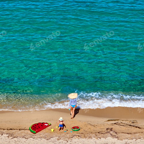Preview: Boy and his mother on beach with inflatable float