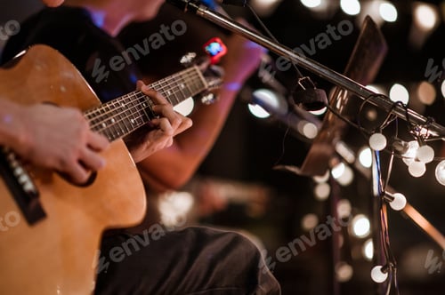 Preview: The musician plays and the lead singer sings on stage at the music festival at night.
