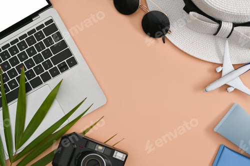 Preview: Laptop computer, retro camera, sunglasses, sunscreen bottles and hat on beige background.