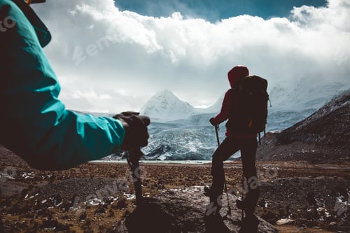 Preview: Two women hikers hiking in winter high altitude mountains