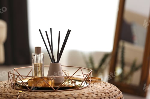 Preview: Composition with stylish accessories and interior elements on wicker pouf indoors