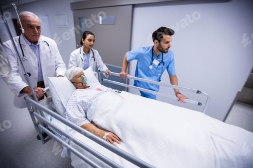 Preview: Doctor and nurse pushing emergency stretcher bed in corridor
