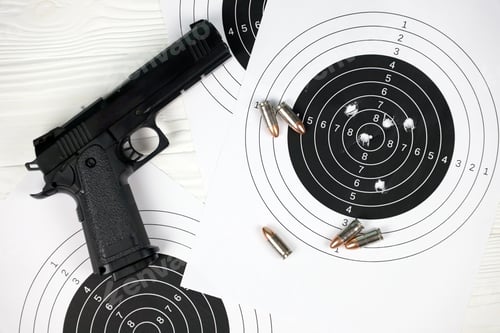 Preview: Gun and many bullets shooting targets on white table in shooting range polygon