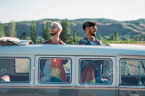 Preview: Gay couple in van holding LGBT flag