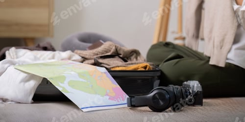 Preview: Young woman traveler packing suitcase preparing for travel on summer vacation