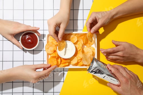 Preview: Potato chips in a bowl with sauces on a light background