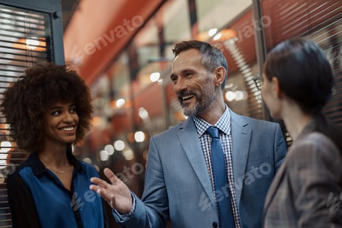 Preview: Multiethnic group of business people talking in office during break. Teamwork concept