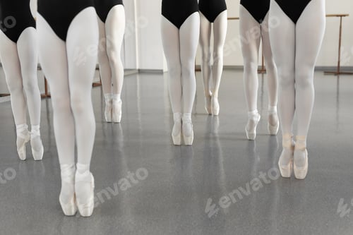 Preview: Legs of a dancer on white pointer shoes in the choreographic hall. Young ballerina