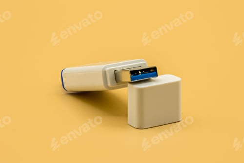 Preview: White and blue USB flash drive placed on its own cap