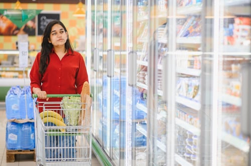 Preview: Indian woman shopping groceries in supermarket aisle