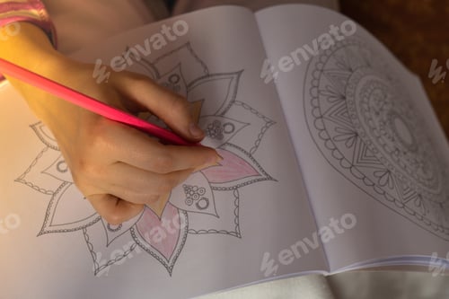 Preview: Female painting mandalas antistress page to combat stress. Relaxing hobby mental wellbeing and art