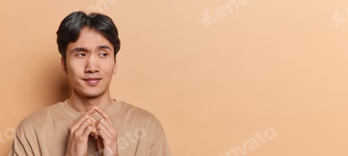 Preview: Handsome Chinese man with dark hair has devious plan cunning face keeps fingers together