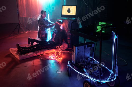 Preview: Young female cyberpunk putting cord around head of man