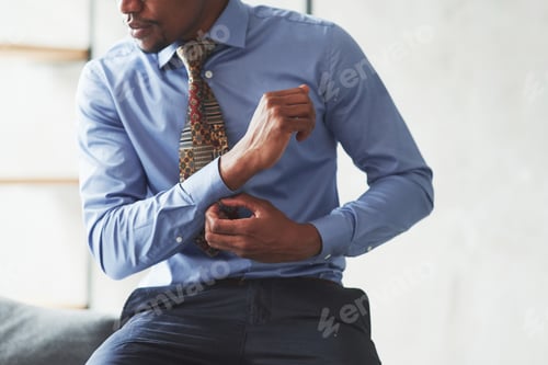 Preview: Man in Shirt Adjusting Cuff