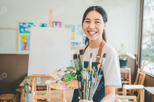 Preview: Portrait of Art student smiling happily while with watercolor