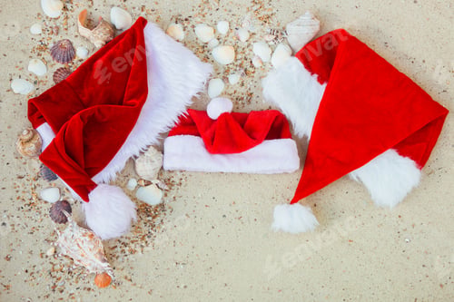 Preview: Christmas hat on the beach. Santa the sand near shells.New year vacation.