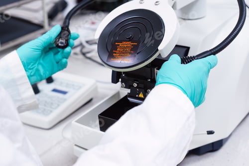 Preview: Scientist inserts lamps of microscope for focusing on a specimen