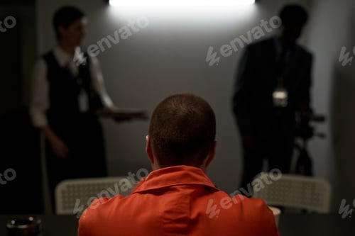 Preview: Caucasian Young Adult Woman Sitting in Interrogation Room Facing Law Enforcement