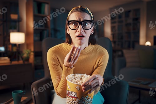 Preview: Woman watching a scary movie on TV