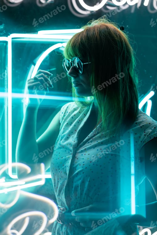 Preview: Cinematic Portrait of girl with sunglasses on neon lights and reflections on prism