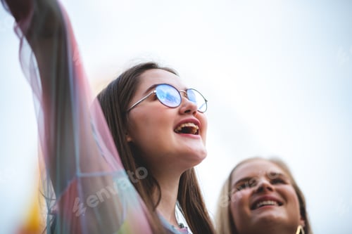 Preview: Group of happy best friends laughing and having fun at amusement park