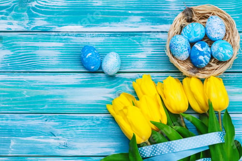 Preview: Easter eggs and tulips. Festive decoration on wood background. Holiday card with copy space