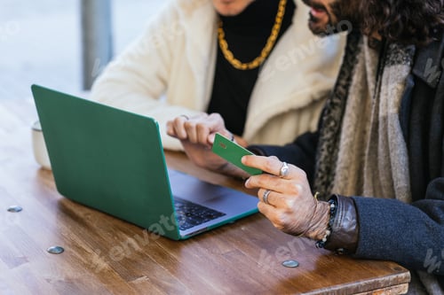 Preview: Gay couple shopping online using laptop and credit card