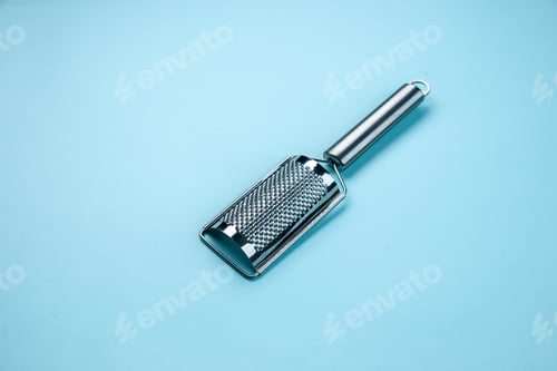 Preview: Top view of stainless kitchen tool on pastel blue background with free space