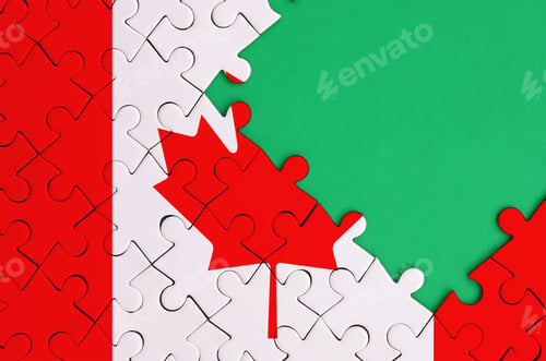 Preview: Canada flag is depicted on a completed jigsaw puzzle with free green copy space on the right side.