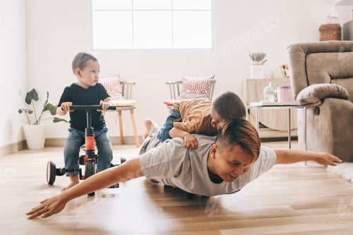 Preview: Dad Playing Airplane with Children Inside Home