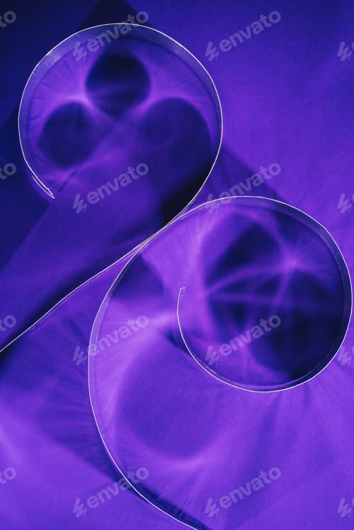 Preview: elevated view of shining paper spirals on purple