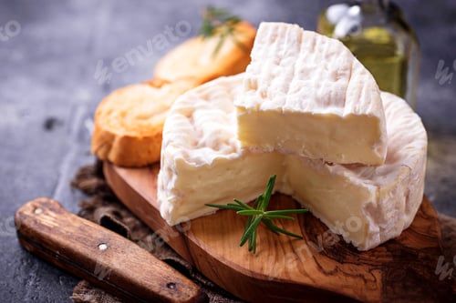 Preview: Camembert cheese with rosemary on wooden board
