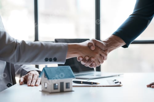 Preview: Real estate agent shakes hands with a client to sign a home purchase contract congratulating the cli