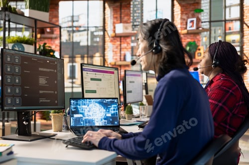 Preview: Team of multiethnic call center workers at office desk using AI