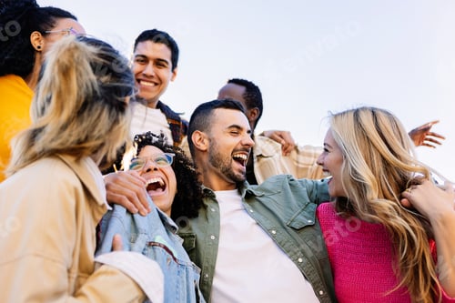 Preview: Young group of diverse people having fun together at city street
