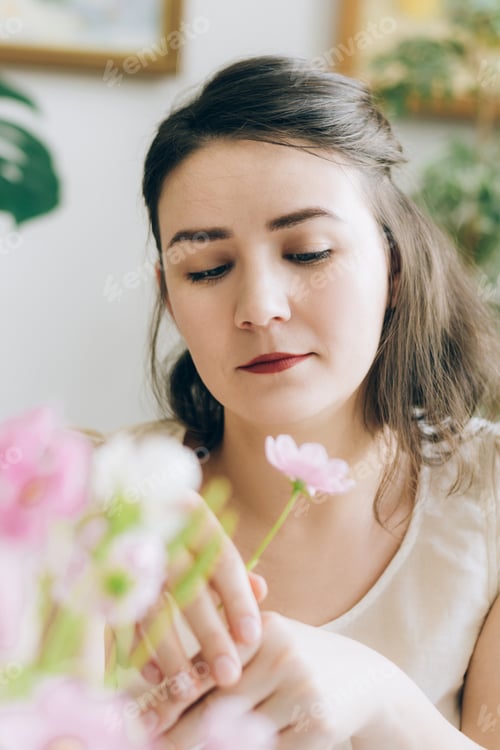 Preview: Portrait of a bored woman holding a flower