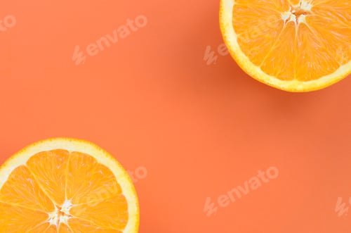 Preview: Top view of a several orange fruit slices on bright background in orange color