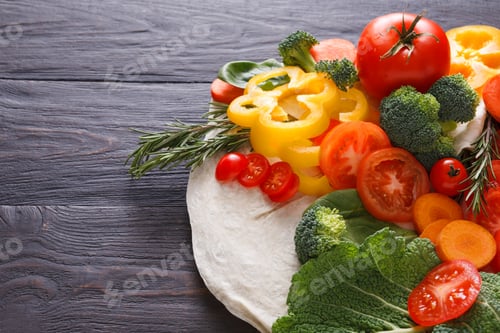 Preview: Fresh vegetables on pita bread background with copy space