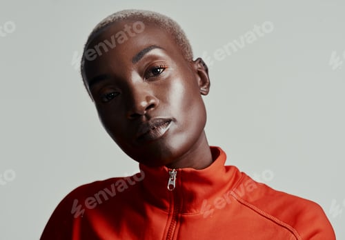 Preview: Studio shot of an attractive young woman in sportswear against a grey background