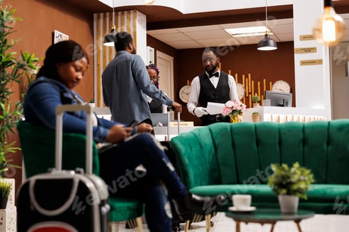 Preview: Hotel receptionist registering guest