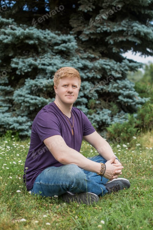 Preview: Man sits on the grass during lunch break