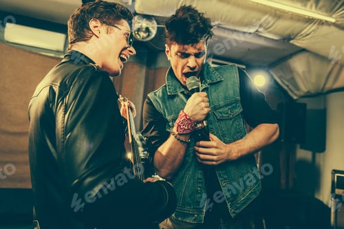 Preview: guitarist in sunglasses playing electric guitar and singing with singer