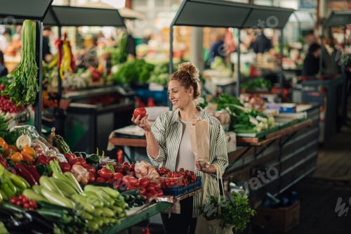 Preview: Smiling customer buying fresh tomato at organic food marketplace.